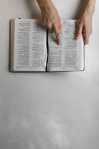 finger pointing to scripture