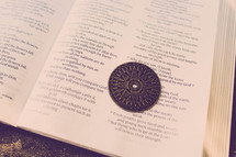 Compass on page of open Bible.