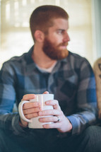 man with a beard drinking coffee 
