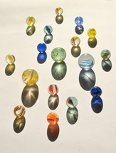 Colorful marbles with shadows on a white background