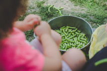 a girl snapping green beans 