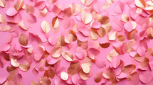 Leaves made of gold and pink on pink background. 