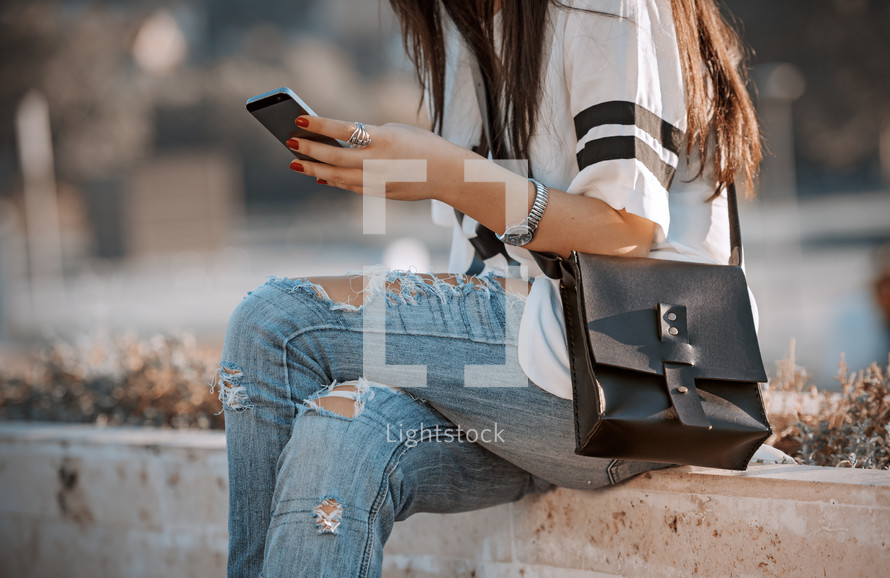 a teen girl looking at a cellphone screen 