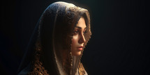 Portrait of the Mother Mary with a veil. Dark background.