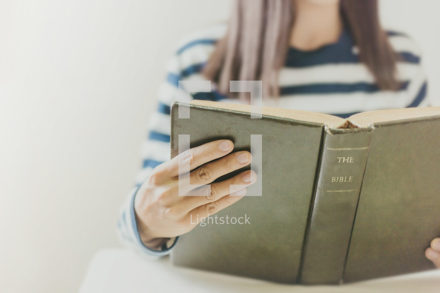 a woman reading a Bible 