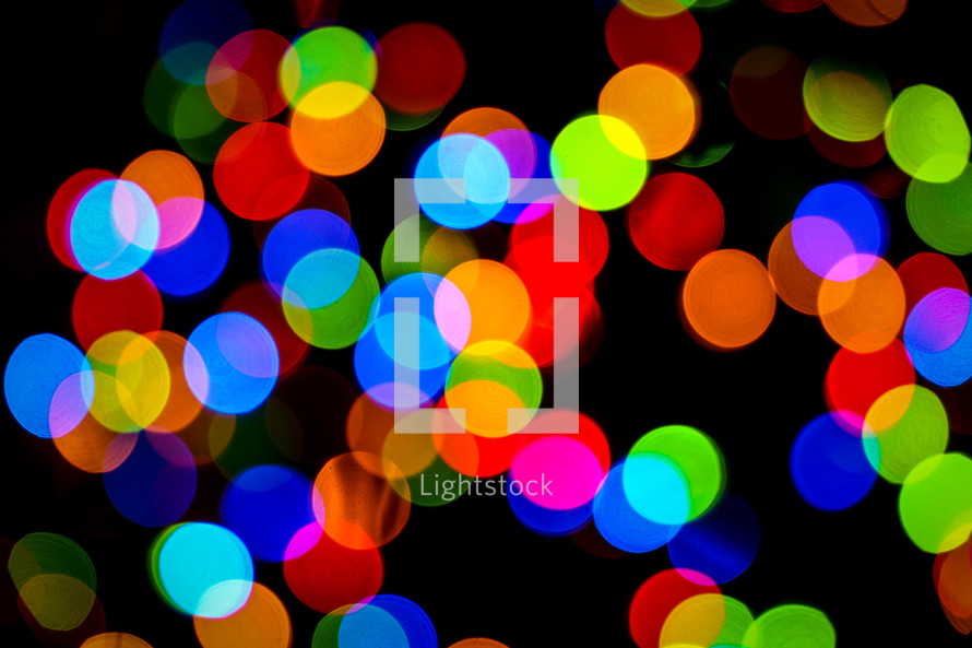 colorful bokeh Christmas lights against a black background 