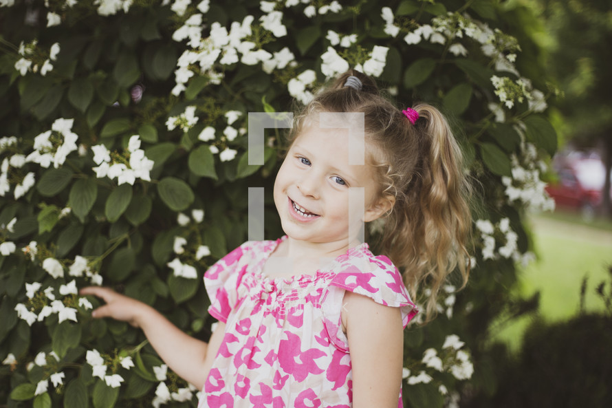 toddler girl with pigtails outdoors in spring 