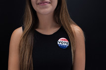 young woman with a vote pin 