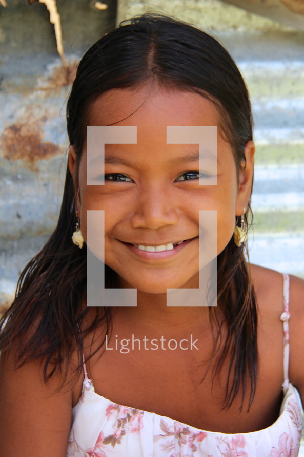 Smiling face of a young polynesian girl 