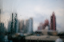 view of a city through a wet foggy blurred window 