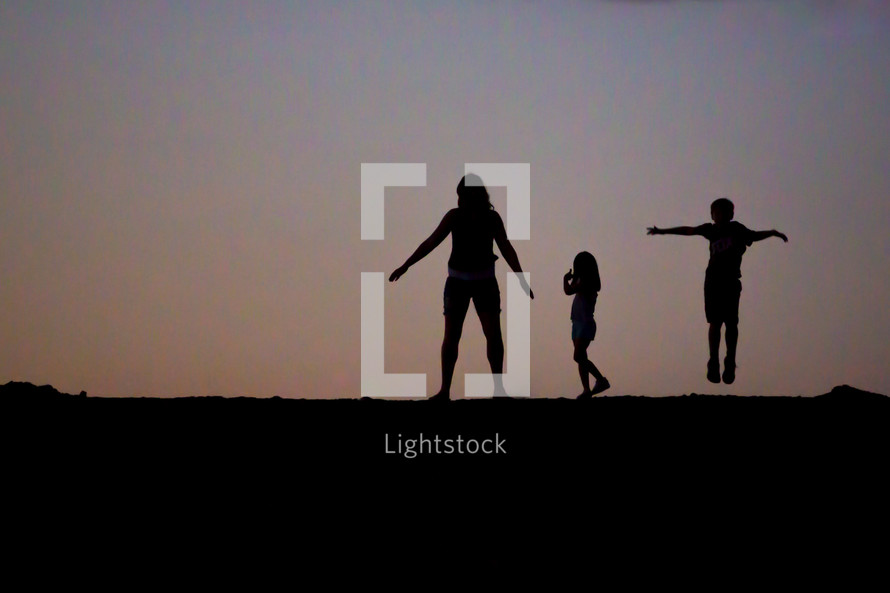 silhouettes of children at sunset 