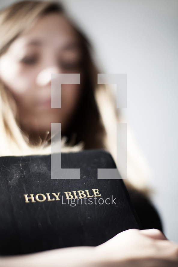 Woman holding a Bible.