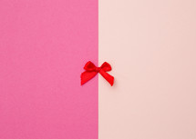 pink background with red bow 