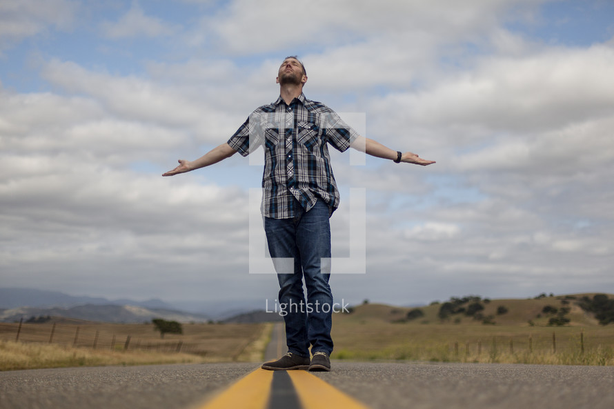 a man standing in the middle of a road 