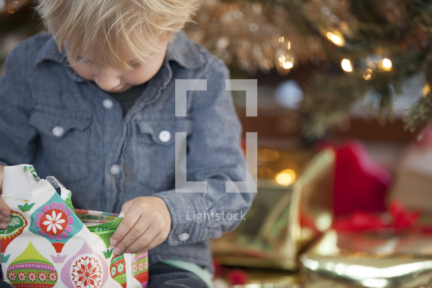 A child opening a Christmas gift. 