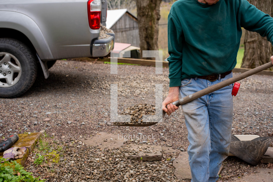 man shoveling gravel 