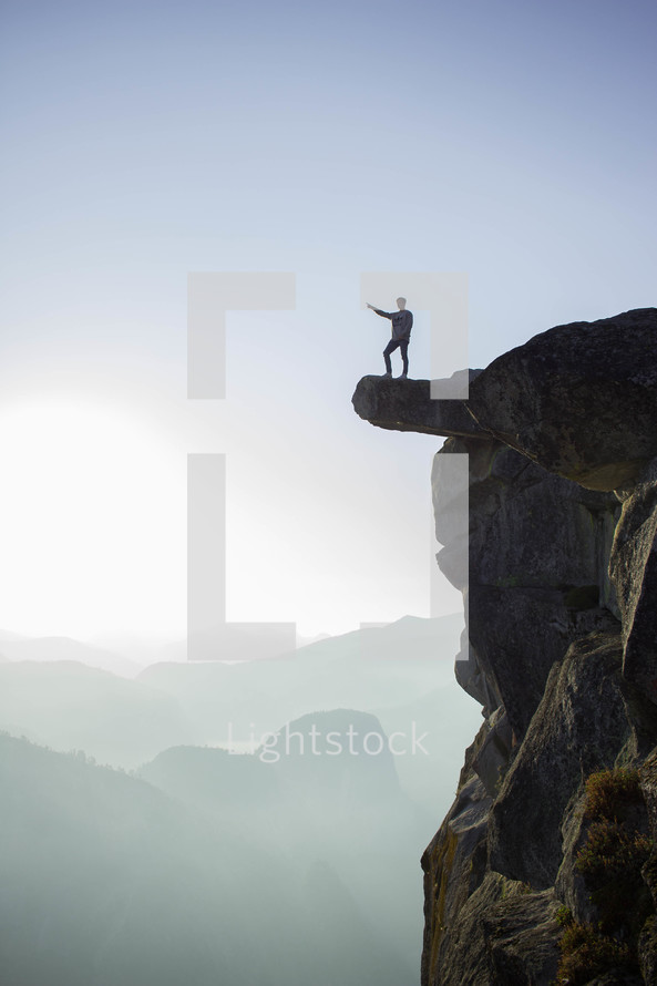 man standing at the edge of a cliff 