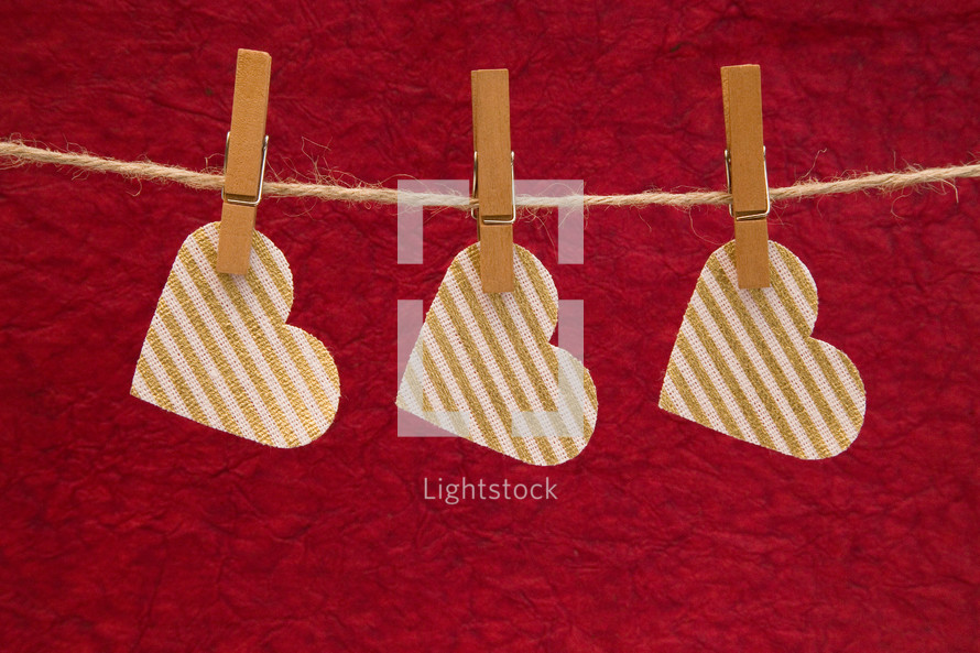 heart shape cutouts hanging by clothespins 