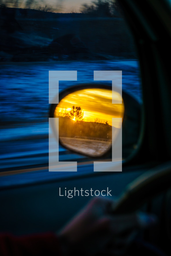 sunset view in a car mirror 