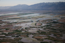A marsh at the foot of a mountain range.