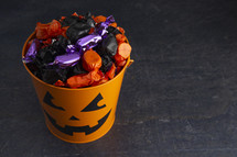 candy in trick-or-treat buckets 