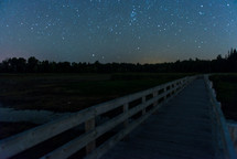 stars over a wooden boardwalk 