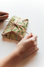 a woman wrapping a gift 