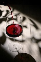 Abstract shadows, sunlight and Glass Of Dry Red Wine
