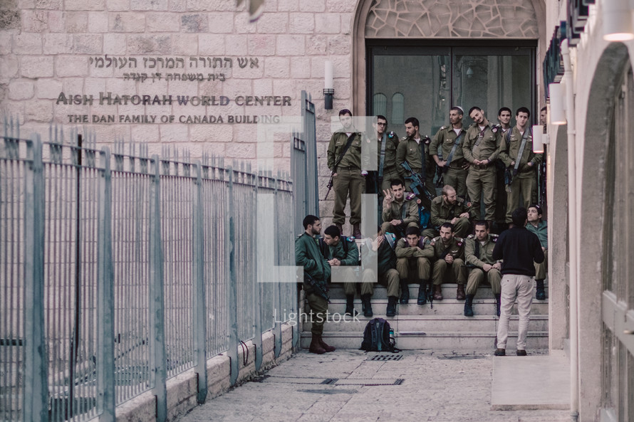 soldiers sitting on steps in Jerusalem 