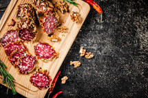 Delicious salami sausage on the table. On a black background. High quality photo