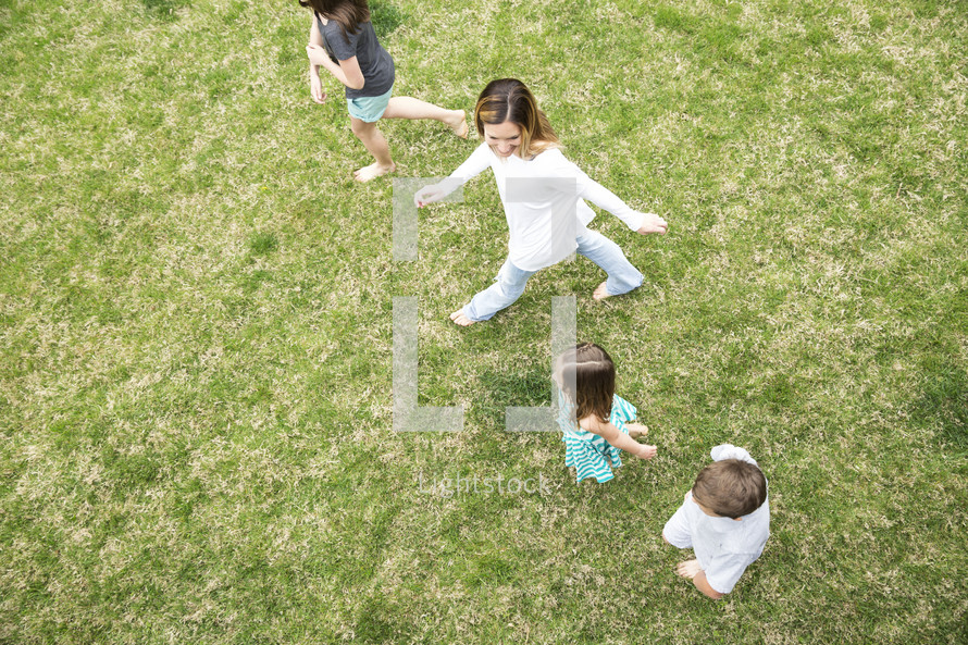 mother and children walking in grass, family, happy, smiling
