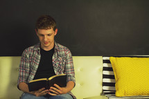 teen boy reading a Bible