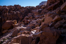 men exploring desert rocks and cliffs 