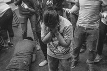people sobbing and crying in surrender at a worship service 
