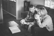 couple drinking coffee and reading a Bible 