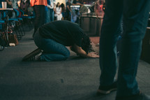 man bowing at church 