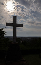 a cross grave marker on a mountaintop 