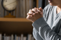 Woman praying with folded hands