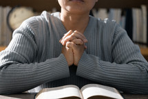Woman praying with her Bible