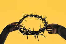Concept Hands holding crown of thorns 