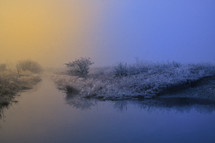 Beautiful winter sunrise and fog on river
