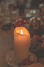 a candle near a Bible at Christmas 