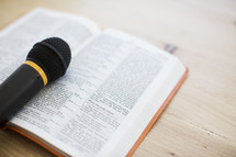 microphone on the pages of a Bible 