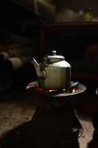 Kettle sitting on hot coals for an Ethiopian coffee ceremony