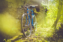 a bike leaning against a stone wall 