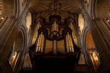 Church organ inside Norwich Cathedral, large pipe organ, beautiful religious architecture