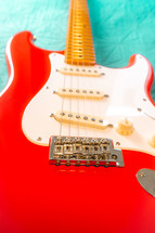 Fiesta Red Squire Stratocaster guitar on a blue background. São Paulo, Brazil, Juli 27, 2024.