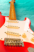 Fiesta Red Squire Stratocaster guitar on a blue background. São Paulo, Brazil, Juli 27, 2024.