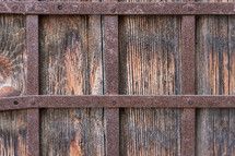 Close up of old wooden door with wrought iron bars