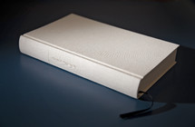 white Bible on blue background 
